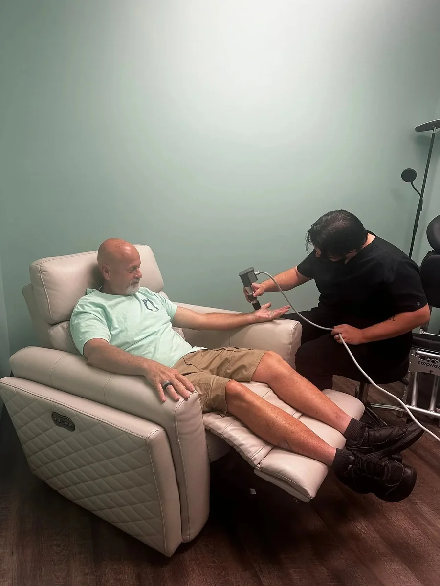 A ProWellness provider performs targeted therapy on a patient’s hand